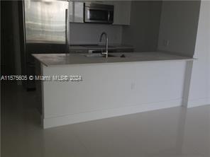 kitchen with sink and black refrigerator