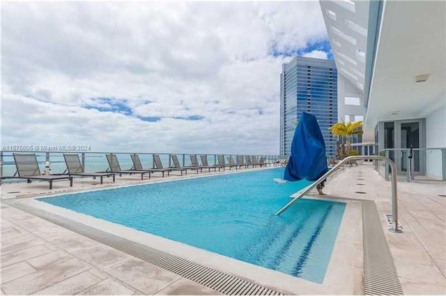 view of swimming pool with a patio