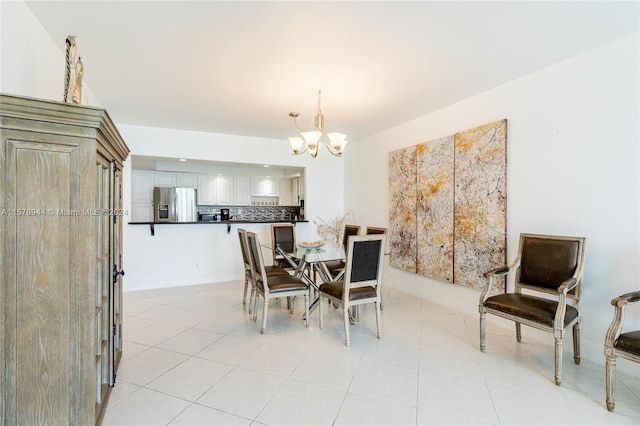 tiled dining room with a notable chandelier