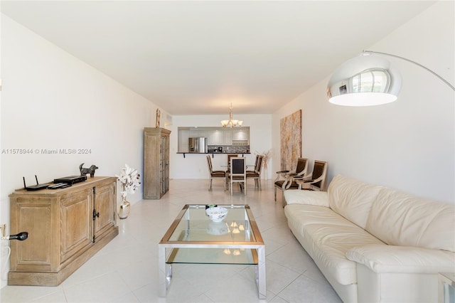 living room featuring light tile patterned flooring and a notable chandelier