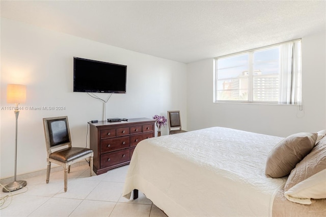 tiled bedroom with a textured ceiling