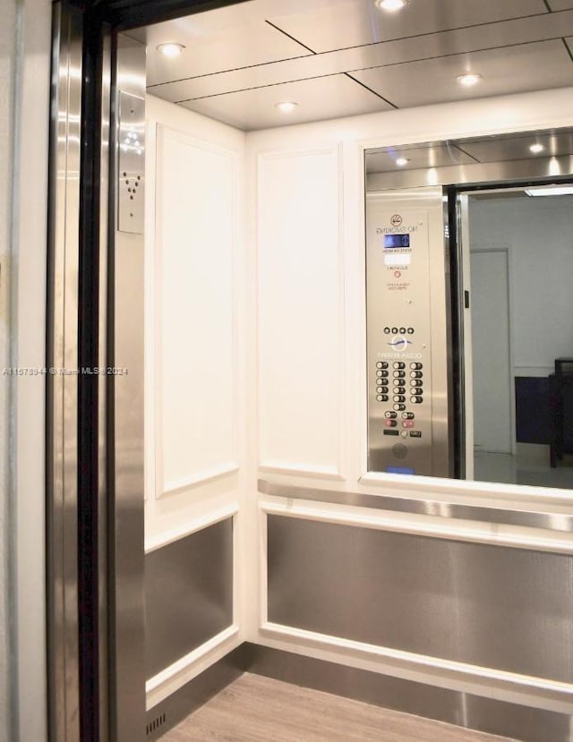 room details with elevator and wood-type flooring