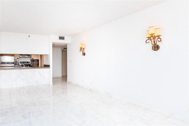 unfurnished living room featuring light tile flooring