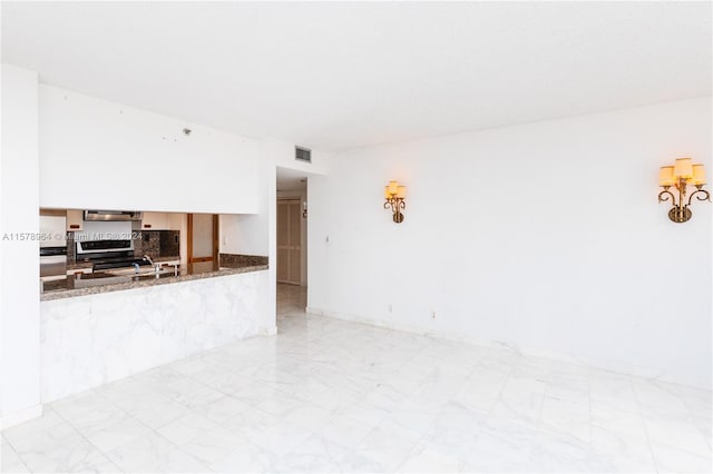 kitchen featuring ventilation hood, stone countertops, light tile floors, and stainless steel electric range oven