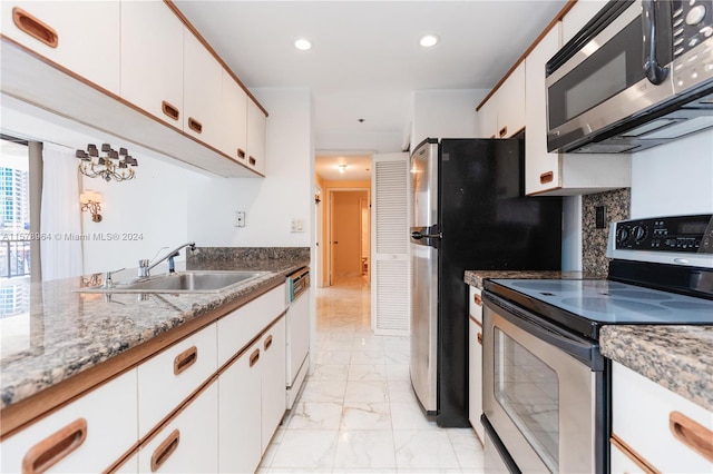 kitchen with white cabinets, sink, stainless steel appliances, and light tile floors