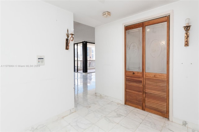 corridor featuring light tile floors