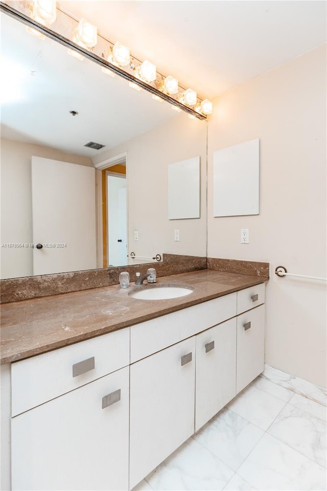 bathroom with vanity and tile floors