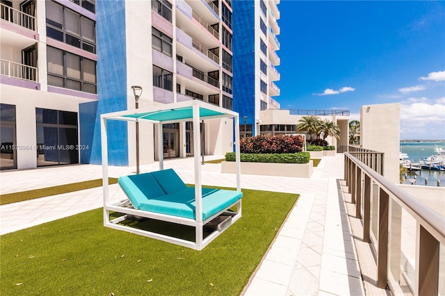 exterior space featuring a water view and a lawn