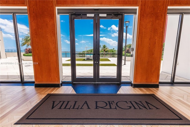 doorway to outside featuring french doors, a healthy amount of sunlight, and hardwood / wood-style floors