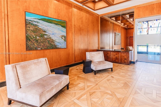 sitting room featuring beam ceiling, parquet floors, coffered ceiling, and wooden walls