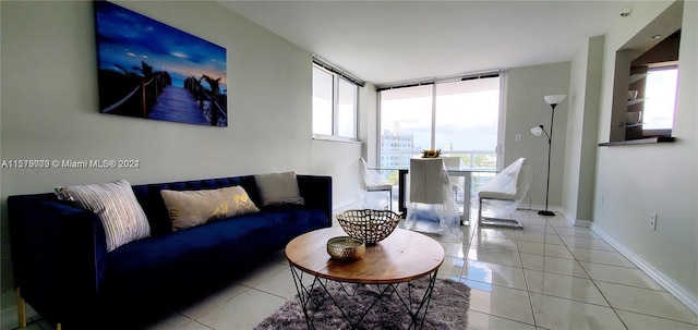 living room with expansive windows and light tile flooring