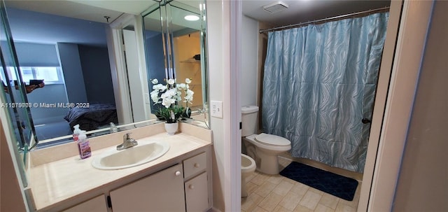 bathroom featuring toilet, tile flooring, and vanity