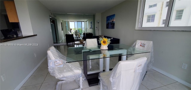 dining area featuring light tile floors