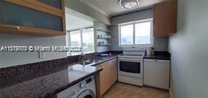 kitchen featuring stove, dishwasher, sink, and washer / clothes dryer