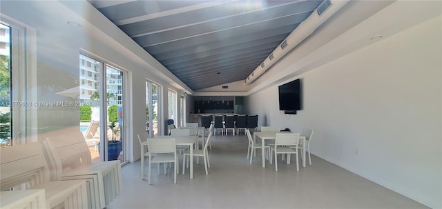 sunroom / solarium featuring lofted ceiling