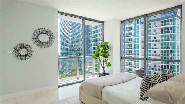 bedroom with expansive windows and access to outside