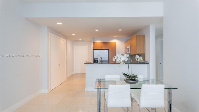 dining area with light tile patterned floors