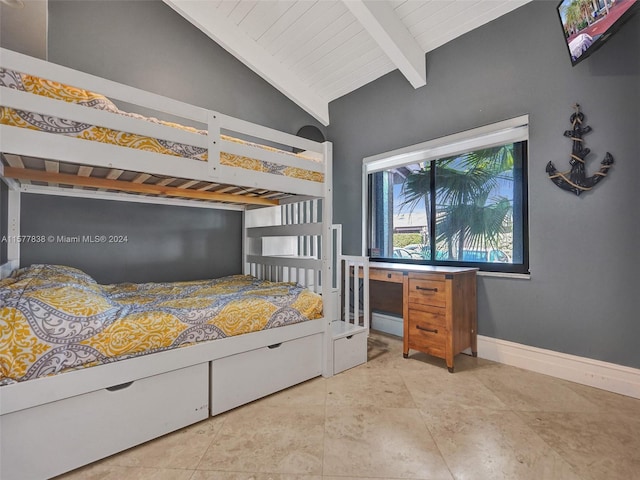 tiled bedroom featuring lofted ceiling with beams