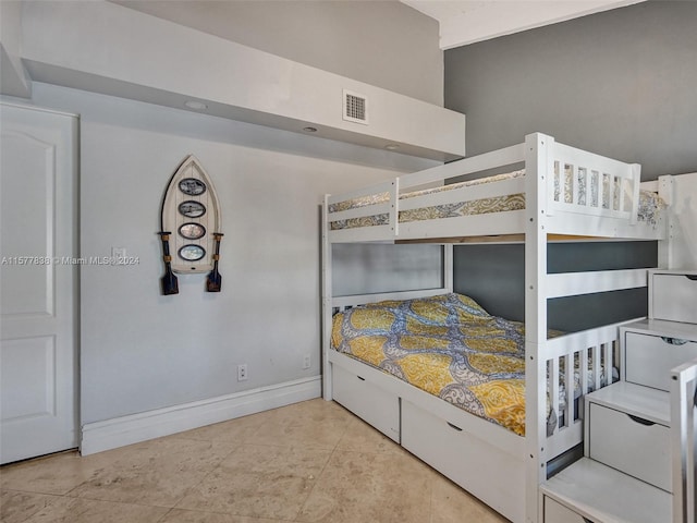 unfurnished bedroom featuring light tile floors