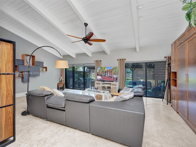 tiled living room featuring ceiling fan and vaulted ceiling with beams