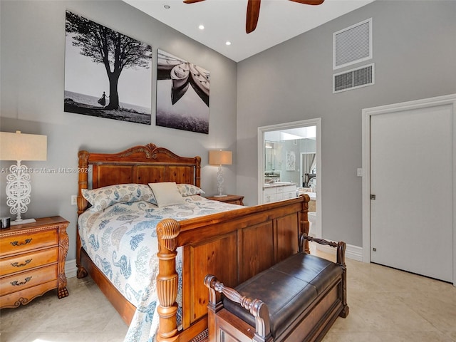 tiled bedroom featuring ceiling fan, ensuite bath, and a towering ceiling