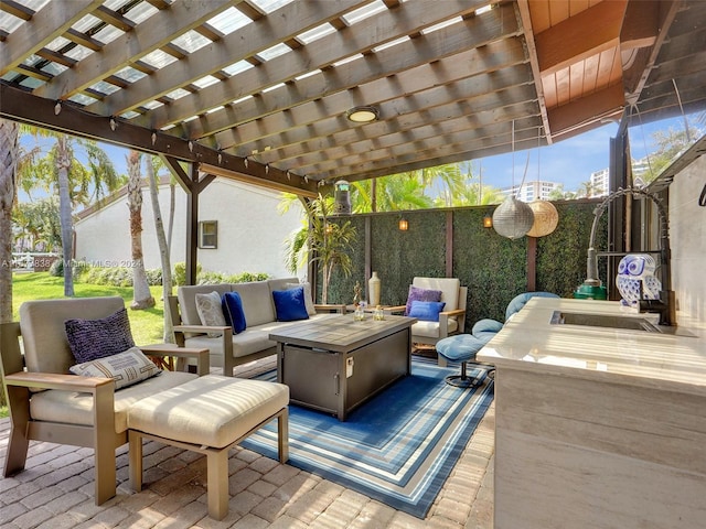 view of patio with a pergola and an outdoor living space with a fire pit