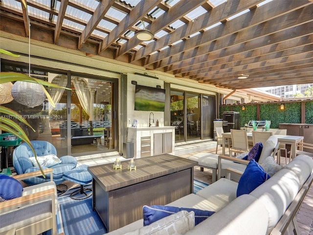 view of terrace with an outdoor living space, sink, and a pergola