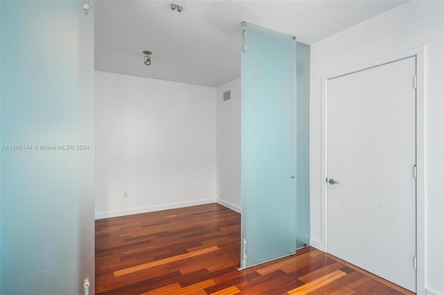 unfurnished room with wood-type flooring