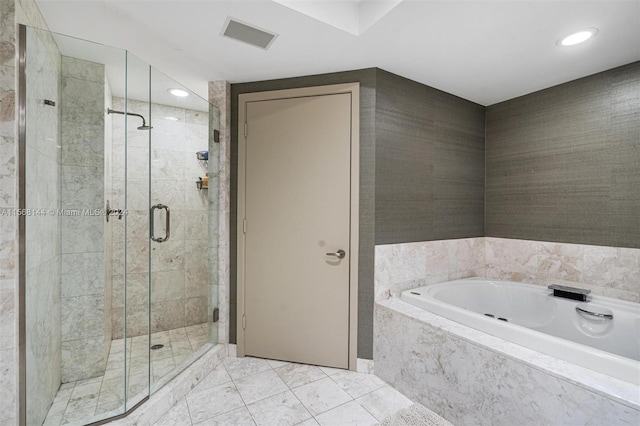 bathroom with tile flooring, independent shower and bath, and tile walls