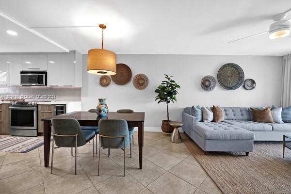 dining room with light tile patterned flooring and ceiling fan