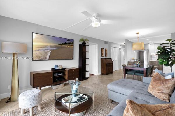 tiled living room featuring ceiling fan