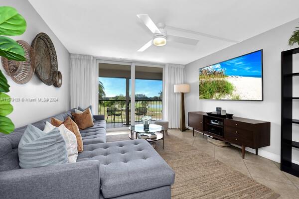 tiled living room with ceiling fan