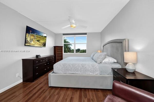 bedroom with dark hardwood / wood-style flooring and ceiling fan