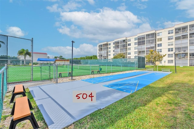 view of basketball court featuring a yard