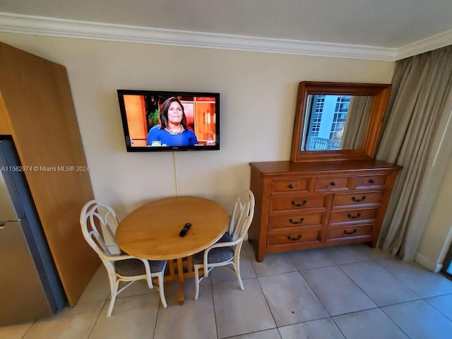 dining space with light tile patterned floors and crown molding