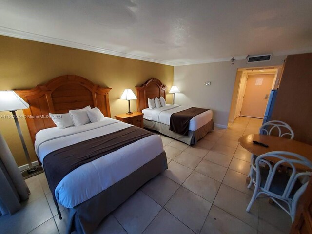 tiled bedroom with ornamental molding