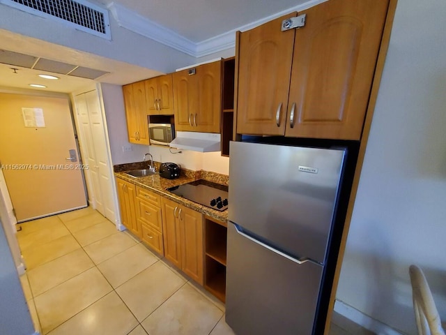 kitchen with stainless steel appliances, visible vents, ornamental molding, light tile patterned flooring, and under cabinet range hood