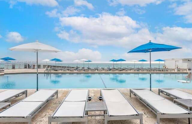 view of pool featuring a water view