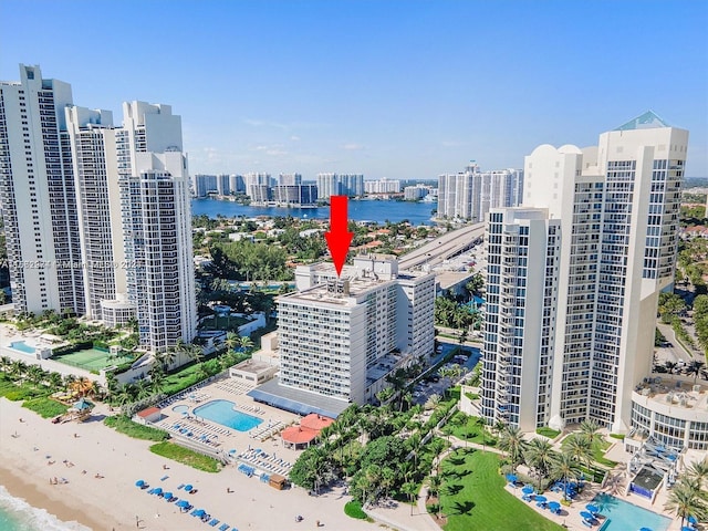 drone / aerial view with a water view and a beach view