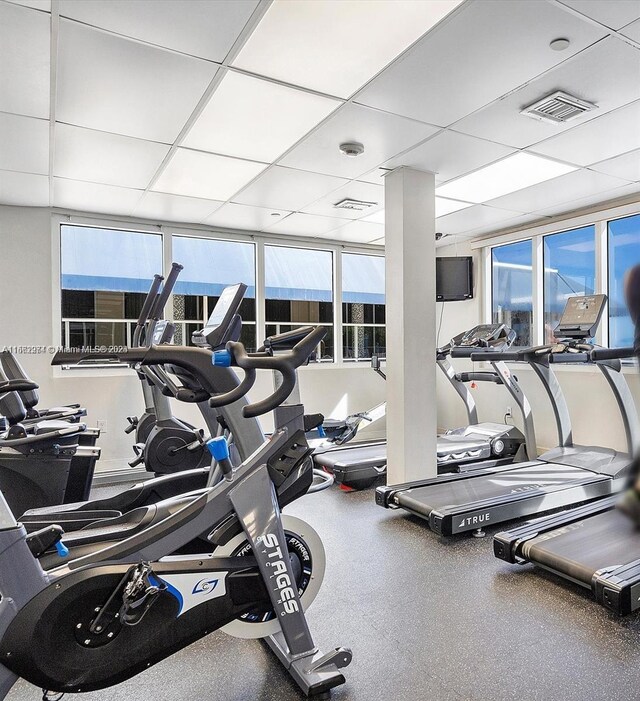 exercise room featuring a paneled ceiling