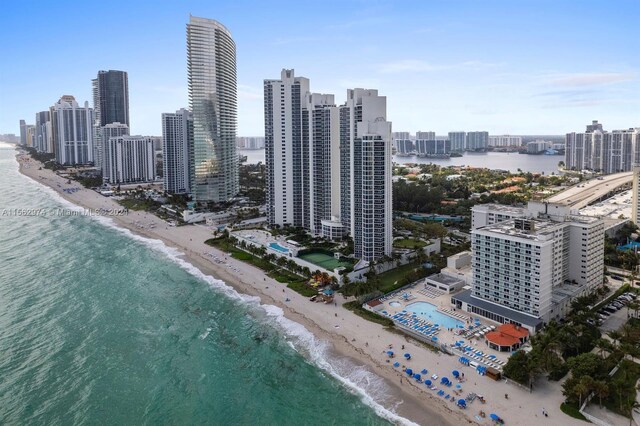 birds eye view of property with a beach view and a water view