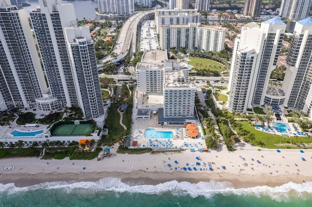 bird's eye view with a water view and a beach view