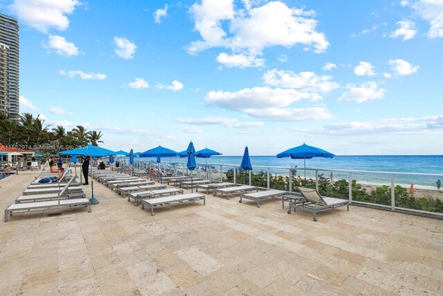 view of patio / terrace featuring a water view and a view of the beach