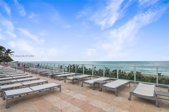 view of patio with a view of the beach and a water view