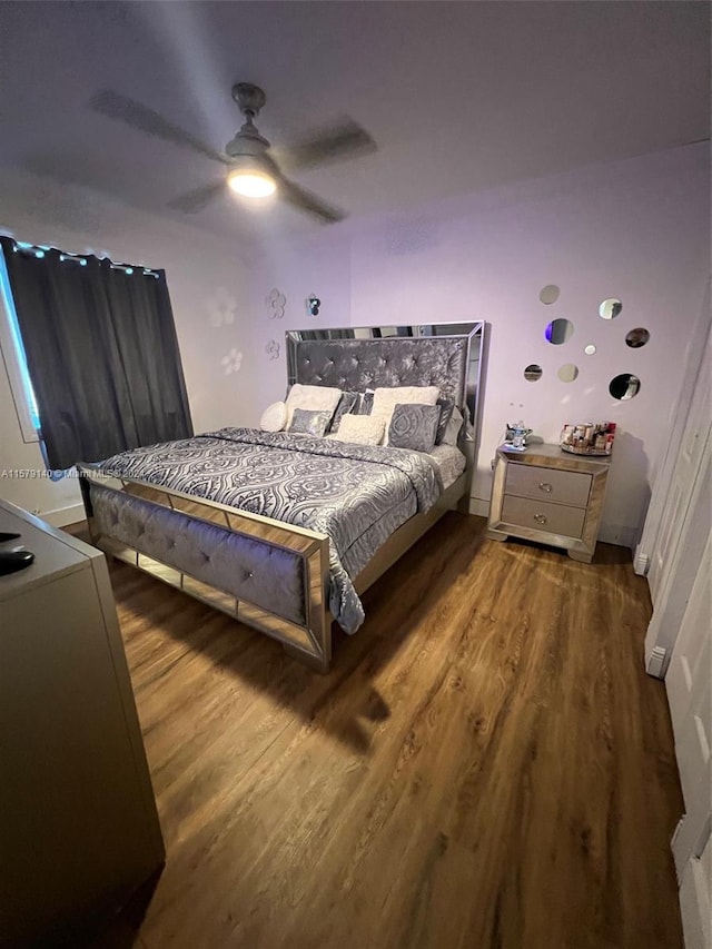 bedroom with wood-type flooring and ceiling fan