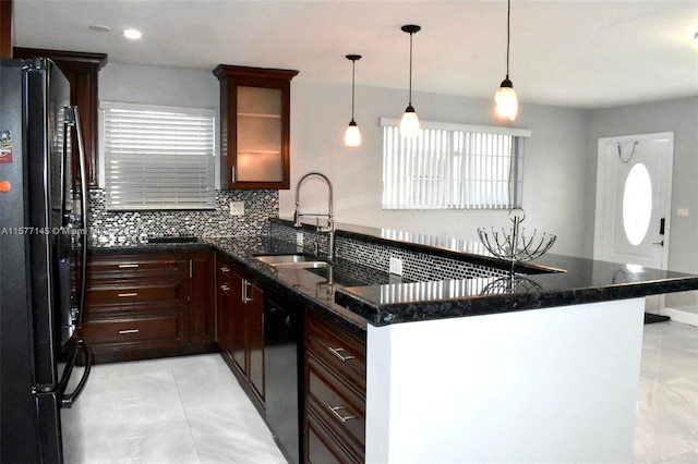 kitchen with tasteful backsplash, pendant lighting, black appliances, light tile floors, and sink