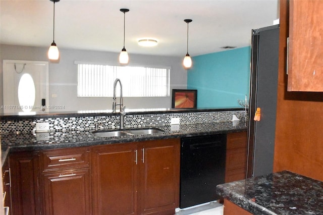 kitchen featuring decorative light fixtures, sink, dishwasher, and tasteful backsplash