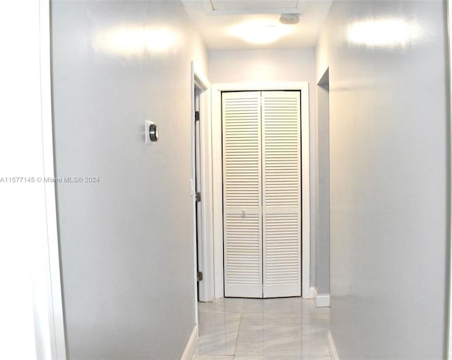 corridor featuring light tile flooring