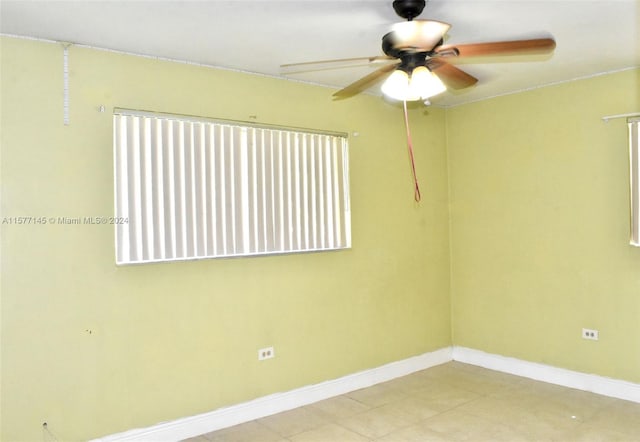 tiled empty room with ceiling fan