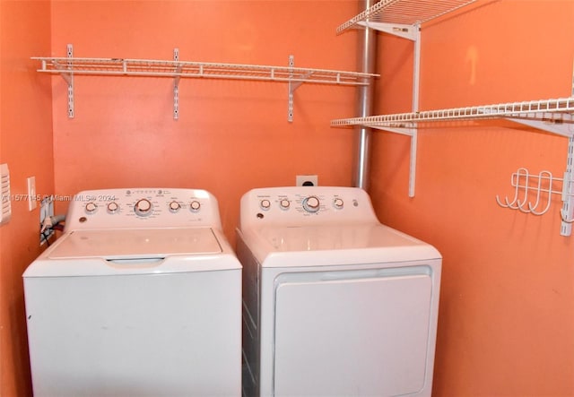 clothes washing area featuring washer and dryer